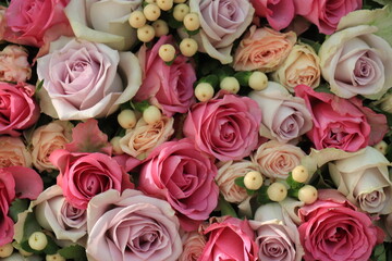 Pink and purple roses in a wedding centerpiece