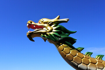 Chinese dragon head isolated against clear blue sky
