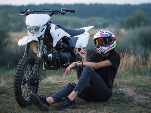 A Young Slender Woman In A Helmet On A Cross - Country Motorcycle Or Pit Bike . Moto Woman