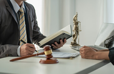 Male attorneys or judges consult teams with clients, business and legal services. The consultant presents the contract signed with the hammer placed in front and concept of justice and lawyer