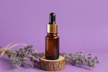 Obraz na płótnie Canvas Cosmetic glass bottle for essential oil Lavender Mockup. Lavender Cosmetics Podium on violet background