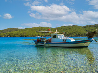 Fototapeta na wymiar Boat on the sea. A fishing boat at sea in Akbük bay in Muğla province of Turkey