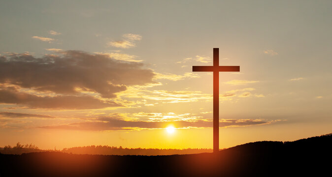 Christian cross on hill outdoors at sunrise. Resurrection of Jesus. Concept photo.