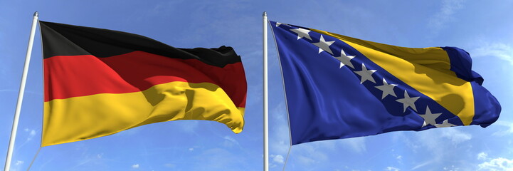 Waving flags of Germany and Bosnia and Herzegovina on flagpoles, 3d rendering