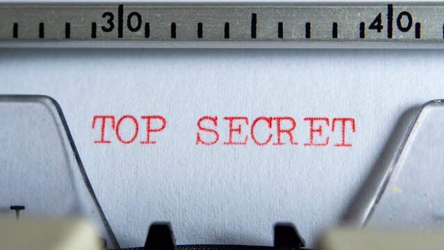 Typing "top secret" on an old electric typewriter