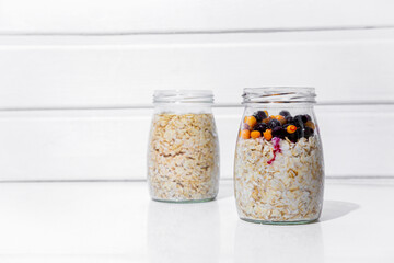 Oatmeal in jars with currants and sea buckthorn