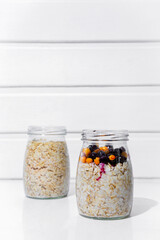 Oatmeal in jars with currants and sea buckthorn