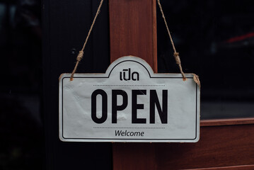 Come In. sign board through the glass of store window.	