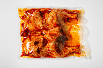 Raw marinated chicken carcass