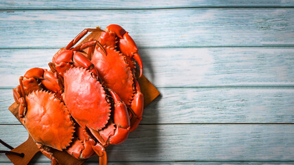 fresh crab on wooden cutting board, seafood crab cooking food boiled or steamed crab red in the seafood restaurant - top view - obrazy, fototapety, plakaty