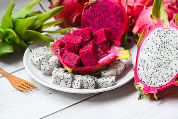 dragon fruit slice and cut half on white plate with pitahaya background , fresh white and red purple dragon fruit tropical in the asian thailand healthy fruit concept - 513736391