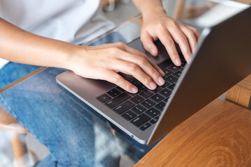 Closeup image of hands typing on laptop computer keyboard