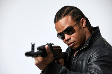 A black African American police detective man on the job with a gun