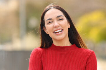 Happy woman in red laughing at camera