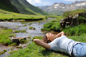 Woman resting in a riverside in the mountain