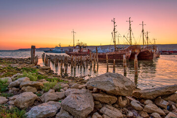 dawn over the pier and old ships