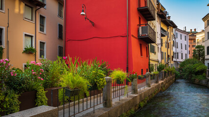 Colorful block and narrow alley facing on a canal. Beautiful old Italian architecture in Udine city, Friuli Venezia Giulia, Italy