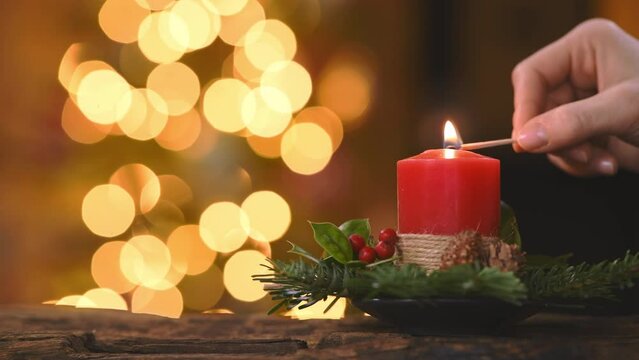 Woman lighting Christmas advent candle