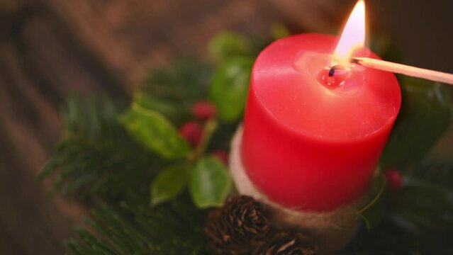 Lighting red Christmas candle