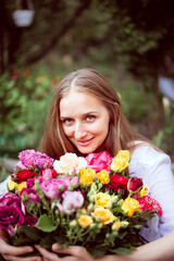 Girl in a greenhouse with roses in spring
