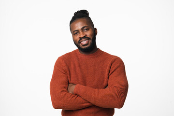 Smiling african-american young man in red sweater with dreadlocks looking at camera with arms...