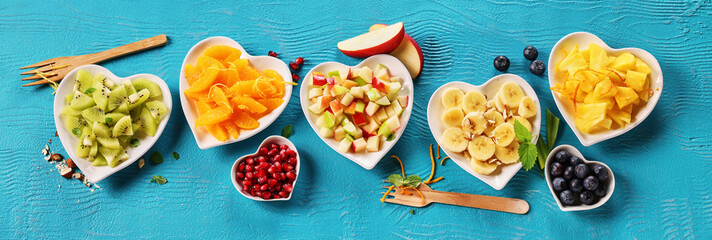 Various ripe fruits in bowls on table