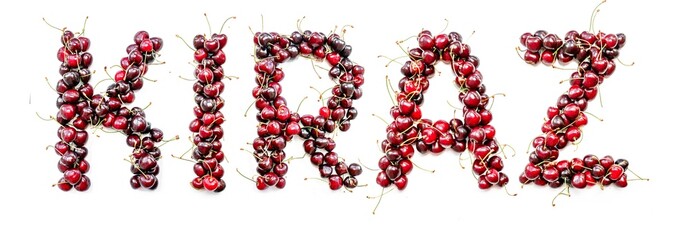 Sweet cherry - a sweet inscription from the berries of ripe cherries in Turkish kiraz. Isolate on a white background, ready-made inscription for design and layout. Great gift and tasty treat