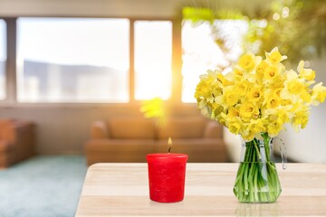 Yellow daffodils flower on the table. Yellow spring home decoration, fresh bouquet of flowers.