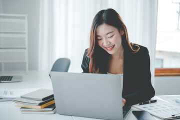 Asian woman working on customer documents, finance, accounting, taxes in the office.