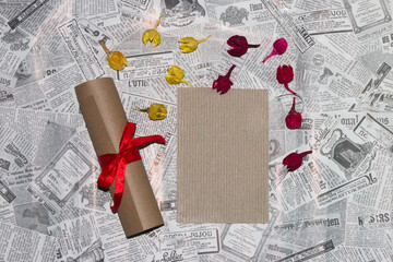 vintage paper as copy space, next to the scroll and around the paper colorful dried flowers, creative retro modern background, invitation, greeting card, wedding