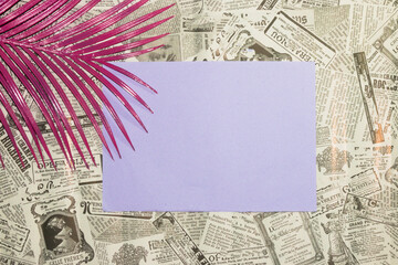newspaper wallpaper with purple copy space in the middle of the background, pink palm leaf in the left corner of the background, creative modern background