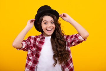 Kids girl in old fashion clothes. Elegent hat, cylinder hat isolated on yellow background....
