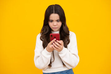 Surprised teenager girl. Teenager child using mobile phone, chatting on web. Mobile app for smartphone. Children lifestyle concept.