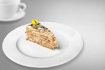 Homemade chocolate cheesecake slice in white plate on cafe background