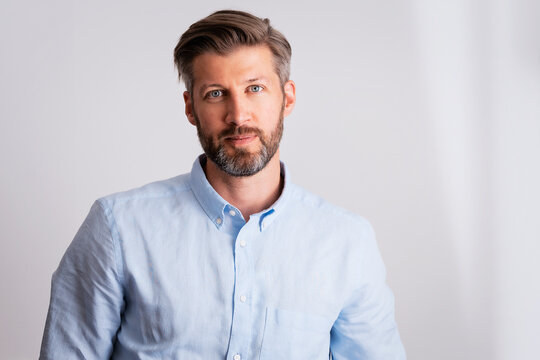 Close-up of confident handsome man studio portrait while standing at isolated background