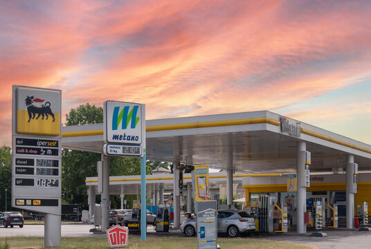 Cuneo, Italy, - June 27, 2022: Eni logo sign with fuel price display and Metano (methane) sign in gas station Eni, it is an Italian oil company worldwide. Expensive fuel price concept. Sunset sky
