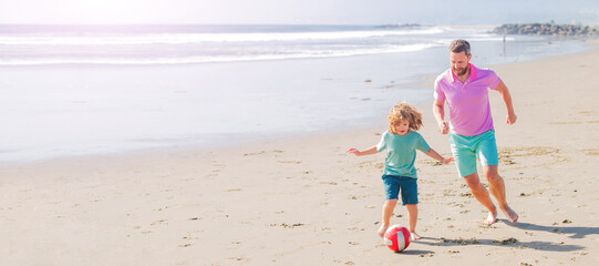 Banner of father and son play soccer or football on beach. happy father and son play football on summer beach with ball, friendship