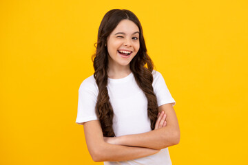 Teenager child girl close one eye, winks and smiling. Human facial emotions concept. Funny winking...