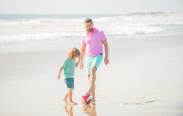 little kid and dad running on beach in summer vacation with ball, football
