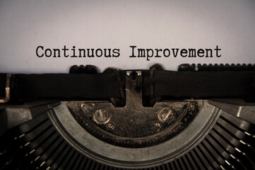Fototapeta na wymiar Continuous improvement text on an old typewriter in vintage color. Business concept