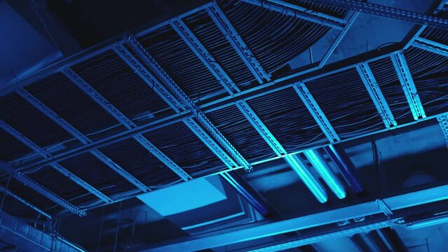 Electrical and air systems communications with cables and metal pipes inside modern building , parking or factory . Concept of electric construction equipment . Communication under ceiling .
