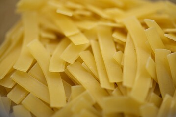 Layout of Italian raw pasta, top view, durum wheat noodles, close-up, macro photo