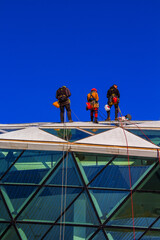 three industrial climbers work at height