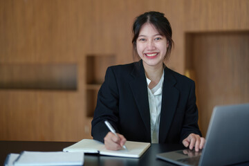 Portrait of an Asian businesswoman working with a happy smile in the office