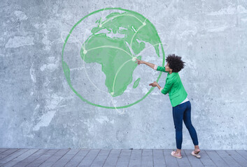 Woman looking at painted globe with communication network