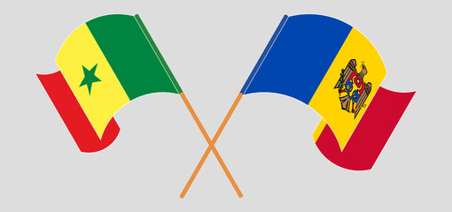 Crossed and waving flags of Senegal and Moldova