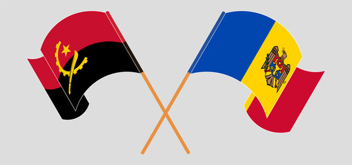 Crossed and waving flags of Angola and Moldova - obrazy, fototapety, plakaty