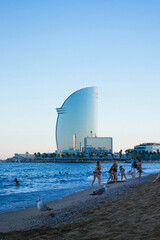 Obraz premium Crowded Barceloneta Beach At The Sunset In Barcelona, Spain