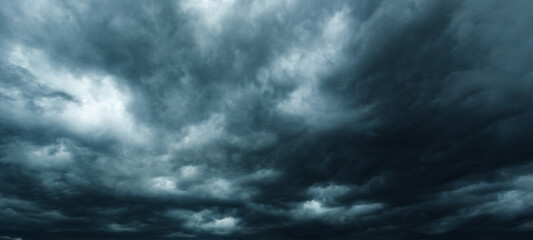 The dark sky had clouds gathered to the left and a strong storm before it rained.Bad weather sky..
