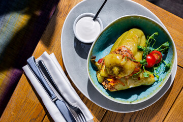 Stuffed peppers with pea sprouts, tomatoes, carrots